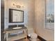 Elegant powder room with designer wallpaper, a stylish vanity, and a modern mirror at 135 James Pl, Maitland, FL 32751