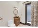 Powder bath featuring a custom vanity with a vessel sink and bronze fixtures at 135 James Pl, Maitland, FL 32751