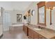 A luxurious bathroom featuring double vanity sinks, granite countertops, and soaking tub at 135 James Pl, Maitland, FL 32751