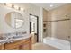 Bathroom showcasing granite vanity, a soaking tub with shower and tiled walls at 135 James Pl, Maitland, FL 32751