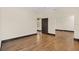 Spacious bedroom with hardwood flooring and large mirrored closet, offering ample storage at 135 James Pl, Maitland, FL 32751