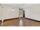 Bedroom features wood floors, window and view to lush landscaping and natural light at 135 James Pl, Maitland, FL 32751