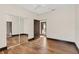 Bedroom features wood flooring, closet with mirrored sliding doors, and neutral paint at 135 James Pl, Maitland, FL 32751