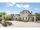 Expansive home boasts a portico, mature landscaping, circular driveway, and a unique tiled roof at 135 James Pl, Maitland, FL 32751