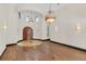 Open foyer boasts hardwood floors, elegant lighting, and a view of the front door at 135 James Pl, Maitland, FL 32751