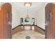 Grand foyer featuring soaring ceilings, hardwood floors, and a view of the backyard pool at 135 James Pl, Maitland, FL 32751
