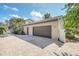 Attached two-car garage with individual doors and brick-paved driveway at 135 James Pl, Maitland, FL 32751