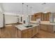 Open concept kitchen with wooden cabinets, stainless steel appliances, and an island with granite countertops at 135 James Pl, Maitland, FL 32751