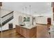 Kitchen island features granite countertops, a sink, and pendant lighting at 135 James Pl, Maitland, FL 32751