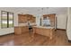 Spacious kitchen featuring a large island with a sink, and custom wood cabinetry at 135 James Pl, Maitland, FL 32751