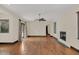 Expansive living room with hardwood floors, ceiling fan and modern fireplace at 135 James Pl, Maitland, FL 32751