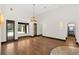 Bright living room with hardwood floors and large windows overlooking the outdoor pool area at 135 James Pl, Maitland, FL 32751