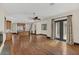 Open-concept living room with wood flooring, a ceiling fan, and kitchen view at 135 James Pl, Maitland, FL 32751