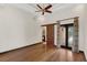 Large primary bedroom featuring wood floors, ceiling fan, and patio access at 135 James Pl, Maitland, FL 32751