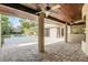 Covered patio featuring brick floors, fans, columns and view of the pool and yard at 135 James Pl, Maitland, FL 32751