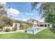Beautiful backyard pool and patio of this home, with solar panels, lush green lawn, and lots of privacy at 135 James Pl, Maitland, FL 32751