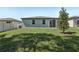 Backyard with a green grass and a tree at 1522 Mermaid Way, Haines City, FL 33844