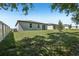 Wide backyard with a privacy fence, lush lawn, and view of neighboring homes at 1522 Mermaid Way, Haines City, FL 33844