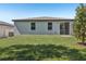 Expansive backyard featuring a sliding glass door leading to the home's interior at 1522 Mermaid Way, Haines City, FL 33844