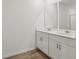 Bright bathroom featuring double vanities with a quartz countertop at 1522 Mermaid Way, Haines City, FL 33844