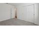 Bedroom features neutral walls and carpet, with an open door and sliding closet doors at 1522 Mermaid Way, Haines City, FL 33844