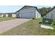 Exterior of modern home featuring an attached garage and brick paver driveway at 1522 Mermaid Way, Haines City, FL 33844