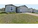Attractive single-story house showing brick driveway leading to a 2-car garage, and manicured lawn at 1522 Mermaid Way, Haines City, FL 33844