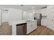 A kitchen island features stainless steel appliances, including a dishwasher, and a double basin sink at 1522 Mermaid Way, Haines City, FL 33844