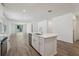A spacious kitchen features an island with stainless steel appliances and an open view to the living room at 1522 Mermaid Way, Haines City, FL 33844