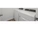 Laundry room features a white washer and dryer with a white door at 1522 Mermaid Way, Haines City, FL 33844