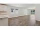 Bright living room with wood-style flooring and sliding glass doors to the backyard at 1522 Mermaid Way, Haines City, FL 33844
