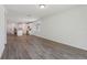 View of open concept living space showcasing wood-look tile and modern kitchen with stainless appliances at 1522 Mermaid Way, Haines City, FL 33844