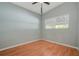 Light-filled bedroom with wood-look flooring, light gray paint, and window at 1600 Hart Ln, Orlando, FL 32804