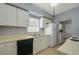 Galley kitchen features white cabinetry and laminate countertops at 1600 Hart Ln, Orlando, FL 32804