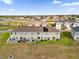The townhome's rear boasts a fenced yard, patio, and solar panels for outdoor living at 1623 Mirabella Cir, Davenport, FL 33897