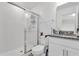 Bathroom featuring modern shower stall, toilet, vanity with granite countertop and white cabinets at 1623 Mirabella Cir, Davenport, FL 33897