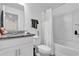 Bathroom featuring modern tub, toilet, vanity with granite countertop and white cabinets at 1623 Mirabella Cir, Davenport, FL 33897