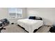 Bedroom with neutral walls and carpet, a large window for natural light, and an inviting bed at 1623 Mirabella Cir, Davenport, FL 33897