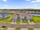 Modern townhomes boast garages, solar panels, and well-maintained front lawns in a Gathering-friendly community at 1623 Mirabella Cir, Davenport, FL 33897