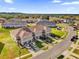 A high angle shot of modern townhouses featuring driveways, garages, and neat lawns in a residential community at 1623 Mirabella Cir, Davenport, FL 33897