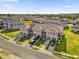 Aerial view showcasing modern townhomes with garages and inviting front lawns within a well-planned community at 1623 Mirabella Cir, Davenport, FL 33897
