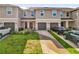 Inviting townhouse with a well-maintained lawn and private garage and driveway at 1623 Mirabella Cir, Davenport, FL 33897