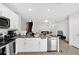 Stylish kitchen with granite countertops, stainless steel appliances, white cabinetry, tile floors and modern fixtures at 1623 Mirabella Cir, Davenport, FL 33897