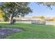 Picturesque backyard featuring a spacious lawn and a deck on the lake at 165 N Pearl Lake Cswy # 202, Altamonte Springs, FL 32714
