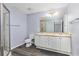 Bathroom with double sink vanity, glass-enclosed shower, and vinyl flooring at 165 N Pearl Lake Cswy # 202, Altamonte Springs, FL 32714