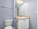 Well-lit bathroom featuring a single sink vanity with white cabinets and a large mirror at 165 N Pearl Lake Cswy # 202, Altamonte Springs, FL 32714