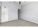 Bedroom with neutral carpet and walls features a closet and doorway leading to other areas at 165 N Pearl Lake Cswy # 202, Altamonte Springs, FL 32714