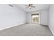 Spacious bedroom with plush carpeting and a sliding glass door providing natural light and access to outdoor views at 165 N Pearl Lake Cswy # 202, Altamonte Springs, FL 32714