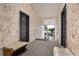 Hallway showcasing the front doors and a comfortable bench for residents and guests at 165 N Pearl Lake Cswy # 202, Altamonte Springs, FL 32714