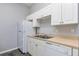 Galley kitchen featuring white cabinets, modern appliances, and a convenient layout for meal preparation at 165 N Pearl Lake Cswy # 202, Altamonte Springs, FL 32714